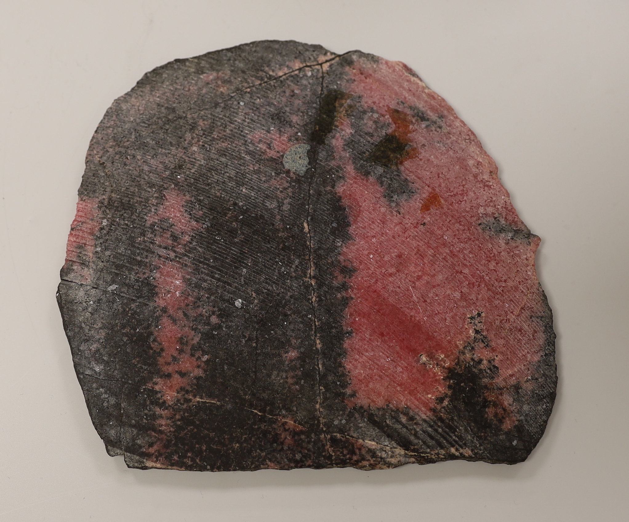 A pink and black quartzite? section. 18cm